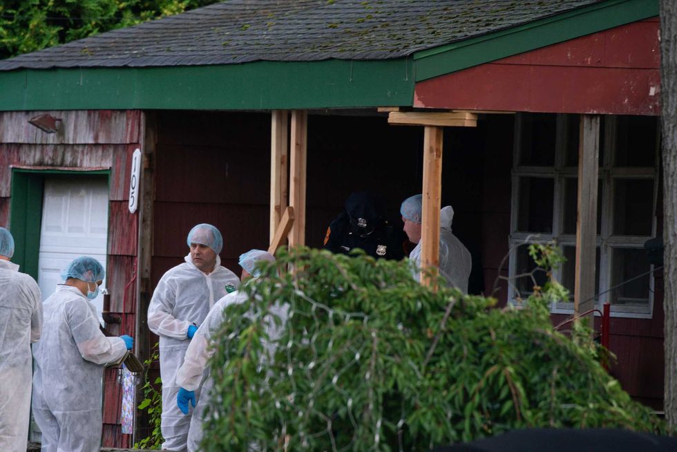 Crime laboratory officers arrive to the house where a suspect has been taken into custody on New York