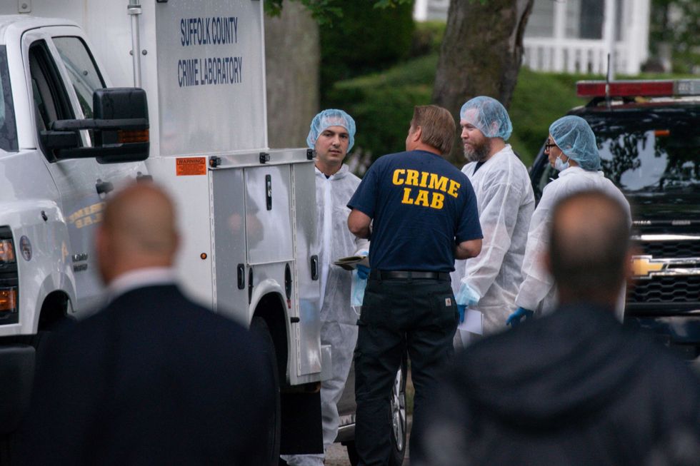 Crime laboratory officers arrive to the house where a suspect has been taken into custody on New York