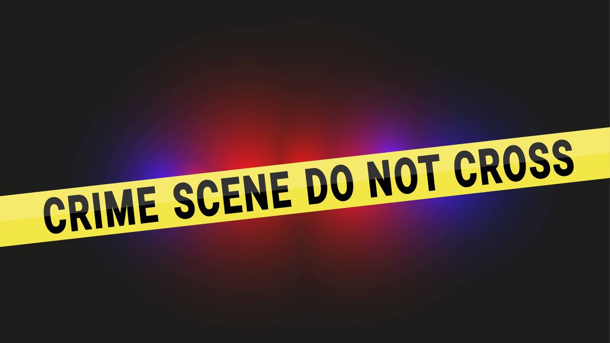 Crime scene do not cross tape with police flashing lights