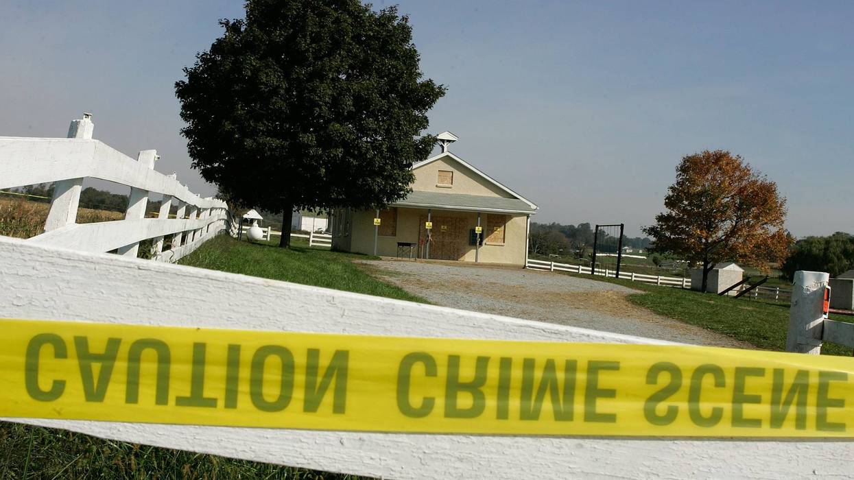 Crime scene tape is attached to a white fence in front of the one room Amish school house where the shooting took place two days prior, October 3, 2006 in Nickel Mines, Pennsylvania. Officials have said a milk truck driver identified as Charles Carl Roberts IV entered the schoolhouse, let the boys and adults go free, tied up the girls and shot them execution style before committing suicide. Five girls are dead and at least seven others injured.