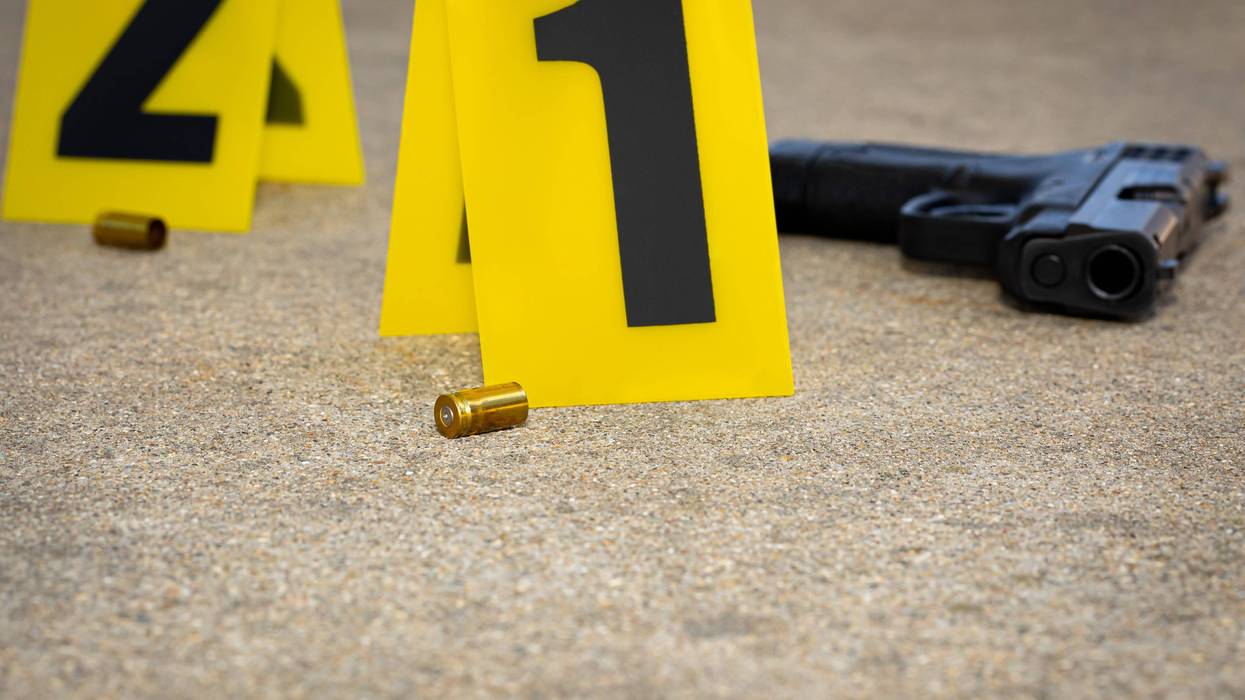 Crime scene with gun and shells on ground