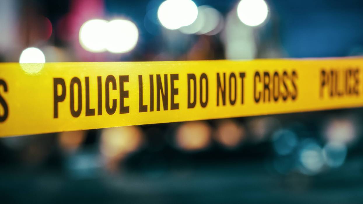 Crime tape with a background of police lights