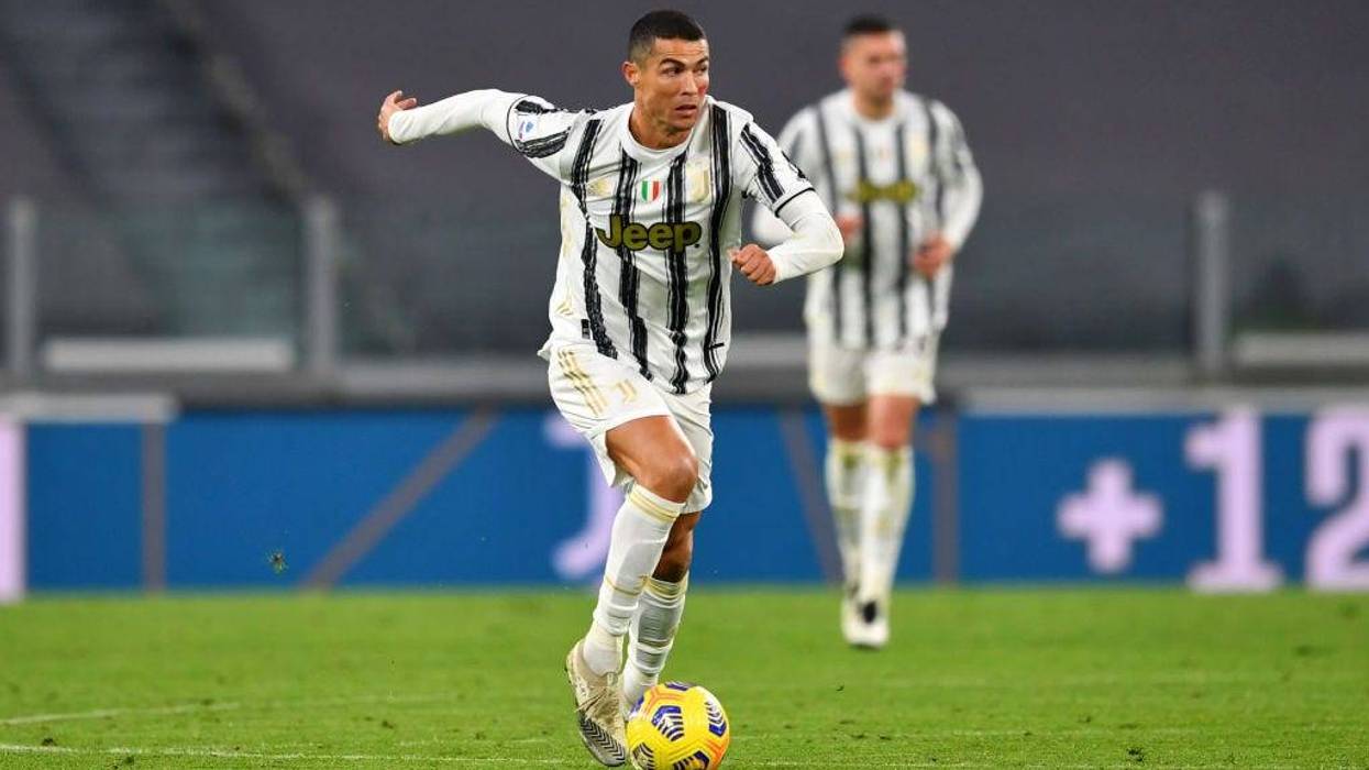 Cristiano Ronaldo of Juventus runs with the ball during the Serie A match between Juventus and Cagliari Calcio at on November 21, 2020 in Turin, Italy. Football Stadiums around Europe remain empty due to the Coronavirus Pandemic as Government social distancing laws prohibit fans inside venues resulting in fixtures being played behind closed doors.