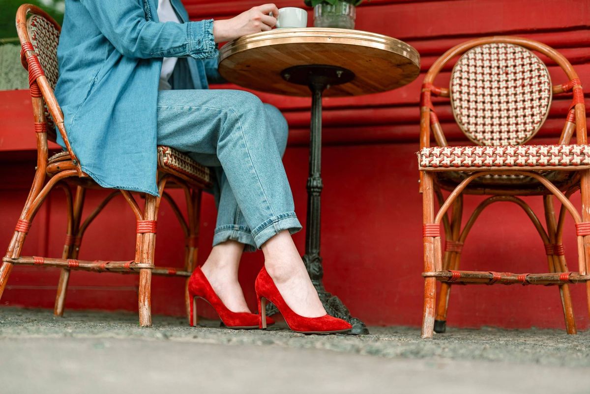 Cropped of young female sitting in cafe with cup of coffee and having relax