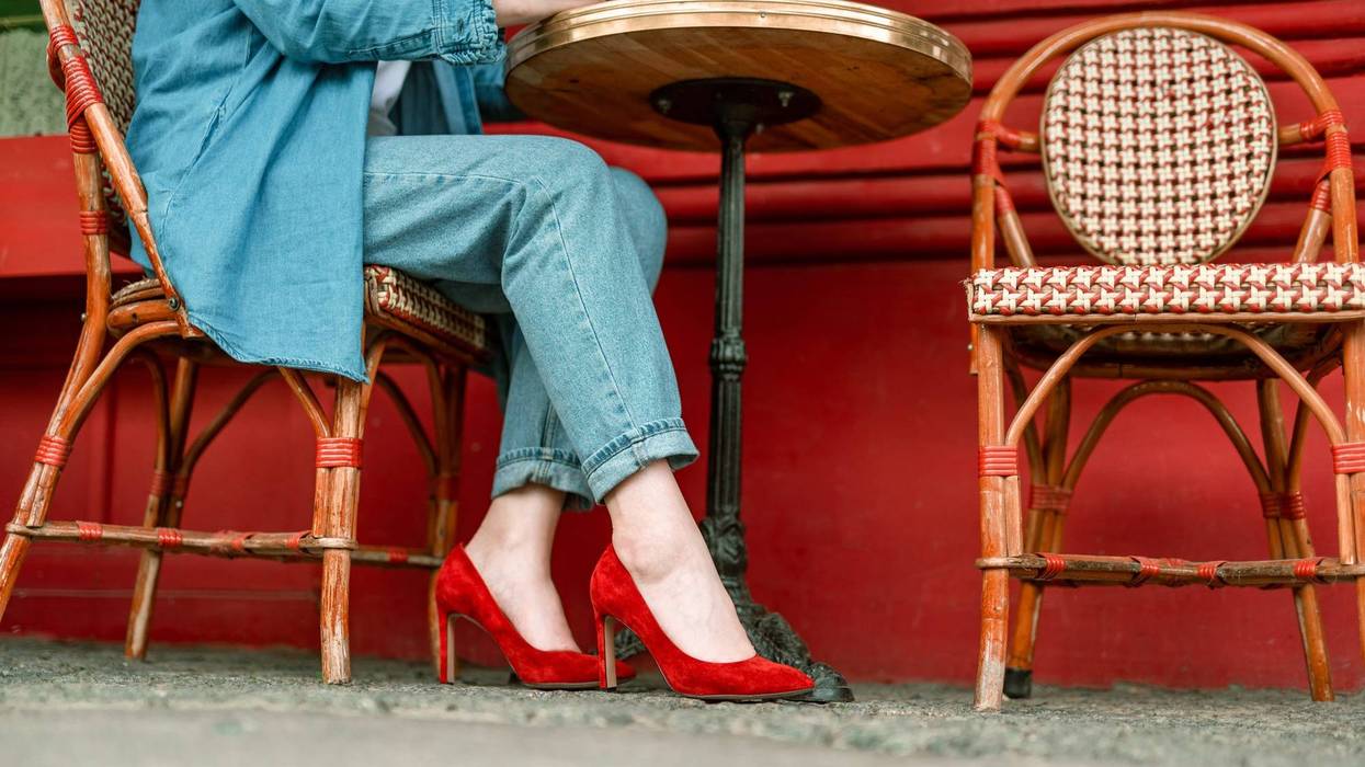 Cropped of young female sitting in cafe with cup of coffee and having relax