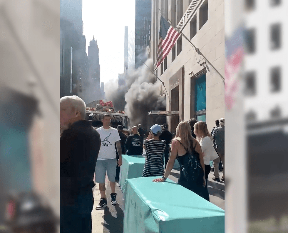 Crowds gathered to watch the fire as smoke poured into the street