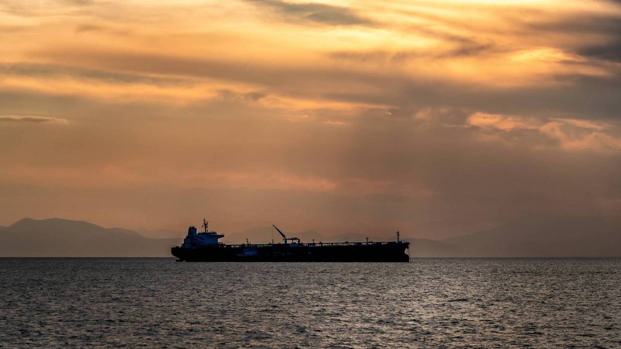 Crude oil tanker in the sea at sunset
