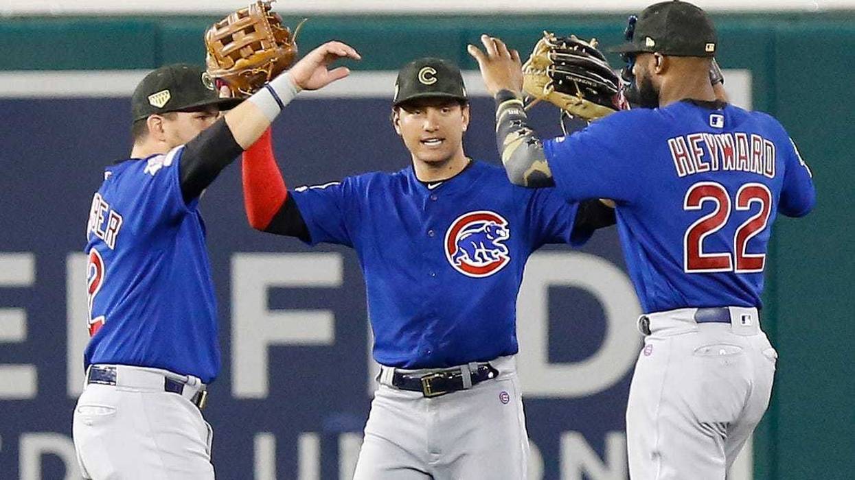 Cubs outfielders Kyle Schwarber (12), Albert Almora Jr. (5) Jason Heyward (22) celebrate. a win.