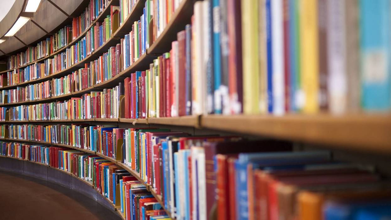 Curved library shelves packed with colorful books.