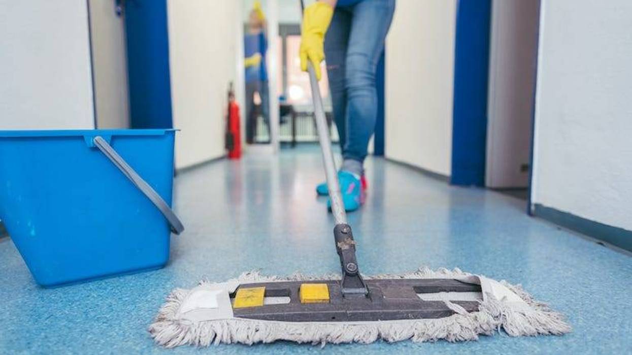 Custodian wiping floor