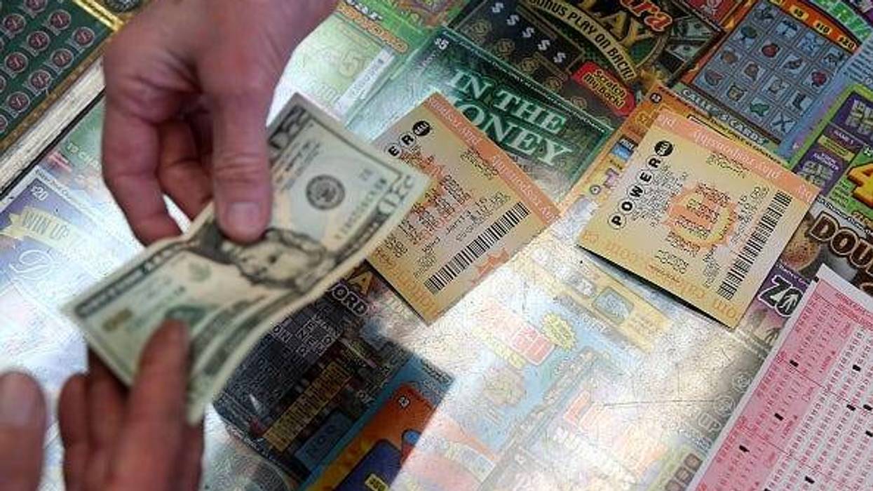 customer buys Powerball tickets at Kavanagh Liquors on January 13, 2016 in San Lorenzo, California. Dozens of people lined up outside of Kavanagh Liquors, a store that has had several multi-million dollar winners, to -purchase Powerball tickets in hopes