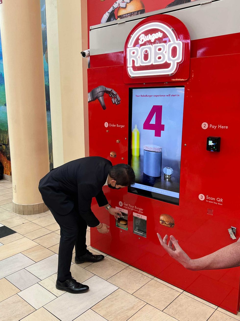 Customer retrieves burger from burger machine