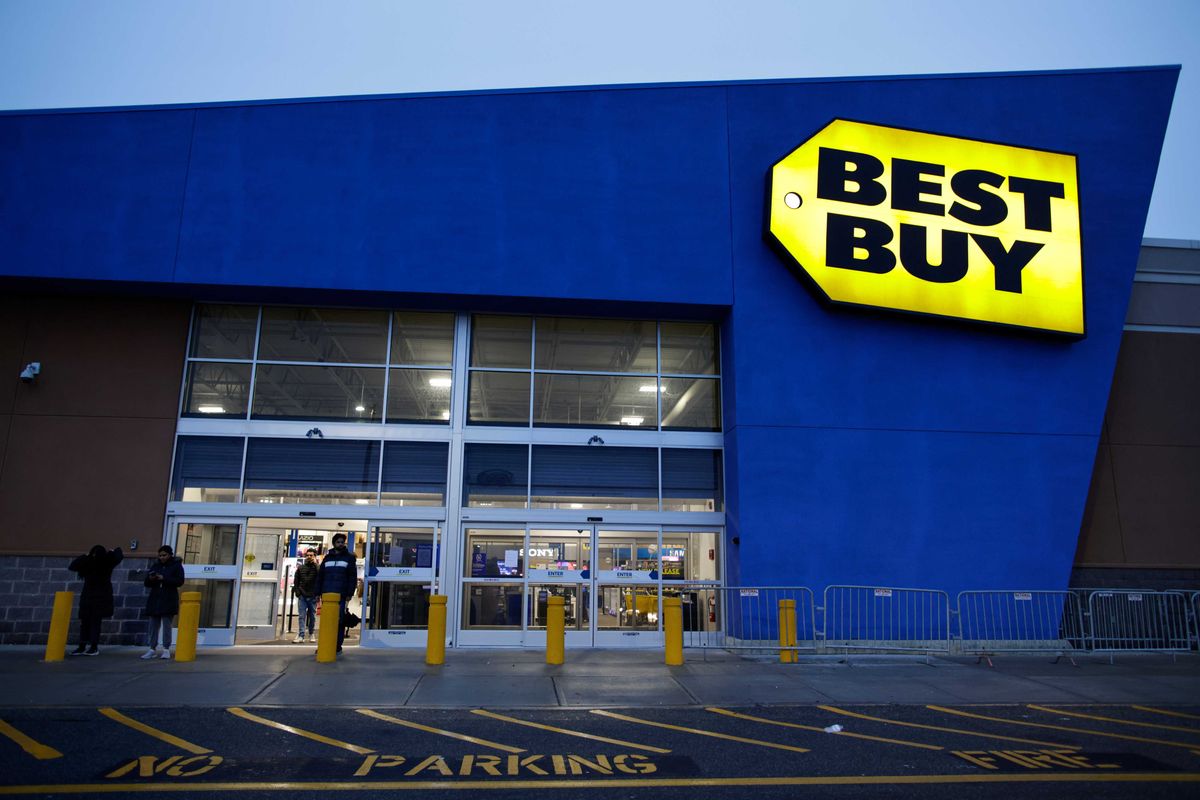 Customers exit from a Best Buy store During Black Friday sales. The Richfield, Minnesota-based retailer lowered its annual sales and profit outlook, sending its shares down 2.6% in premarket trading.