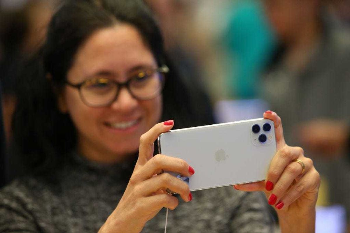 Customers look at iPhone models at Apple Store on September 20, 2019 in Sydney, Australia.