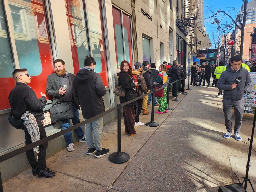 Customers wait in line ahead of USTA