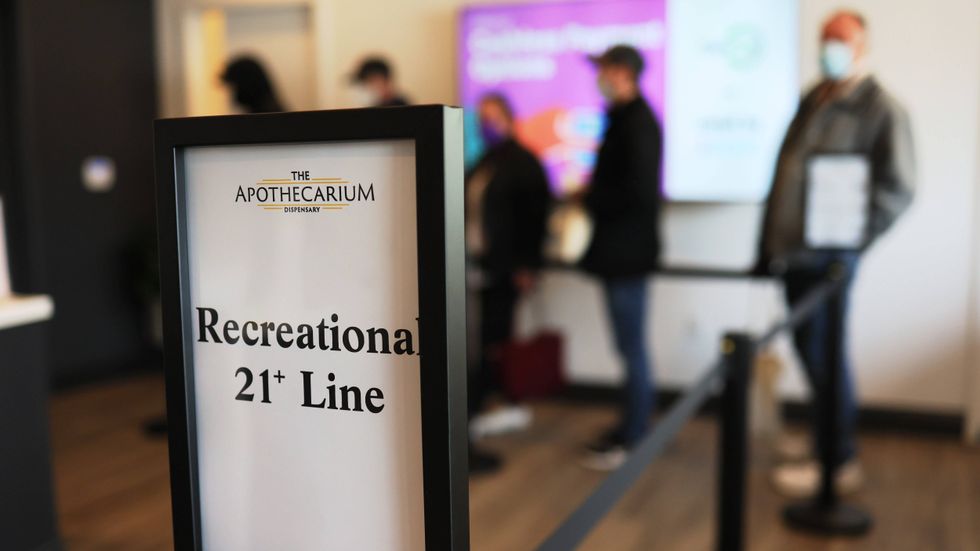 Customers wait in line to enter Apothecarium Dispensary in Maplewood, New Jersey on April 21, 2022, the first day of legal recreational marijuana sales in the state.