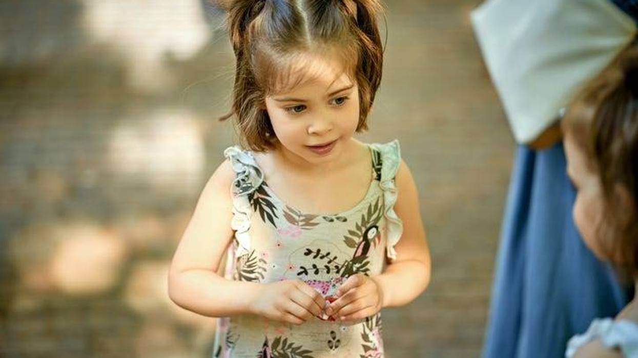 cute little girl at playground on summer day