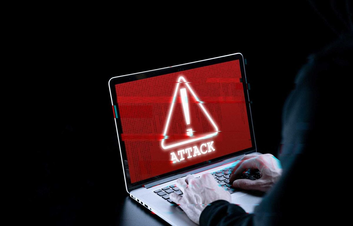 Cyber attack hacker concept. Internet web hack technology. Blurred Digital laptop in hacker man hand isolated on black with glitch effect. Data protection, secured internet access, cybersecurity