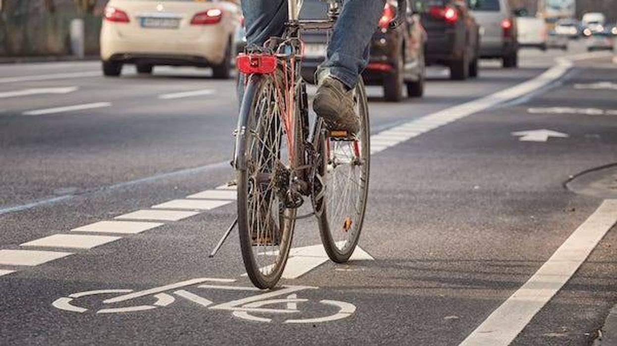 Cyclist riding in a bike lane in a city