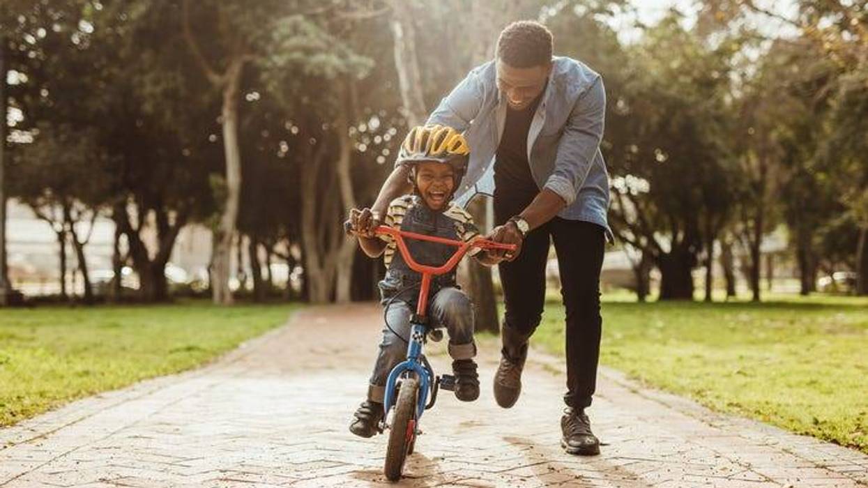 Dad Teaching Son To Ride A Bike