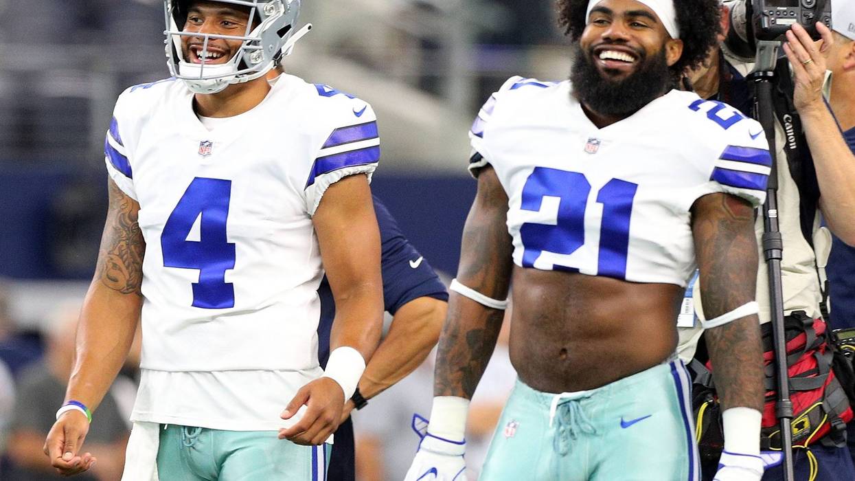 Dak Prescott #4 of the Dallas Cowboys and Ezekiel Elliott #21 of the Dallas Cowboys smile during warm ups before the preseason game against the Arizona Cardinals at AT&T Stadium.