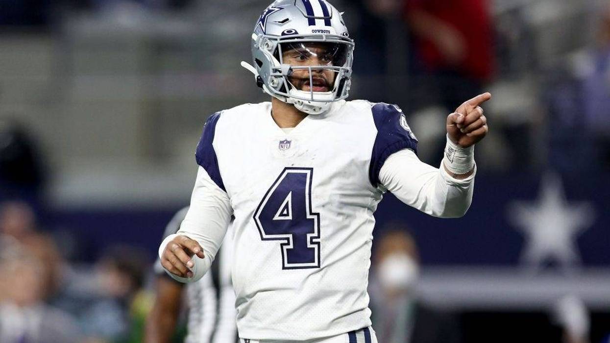 Dak Prescott #4 of the Dallas Cowboys reacts after completing a pass against the Arizona Cardinals in the fourth quarter at AT&T Stadium on January 02, 2022 in Arlington, Texas.