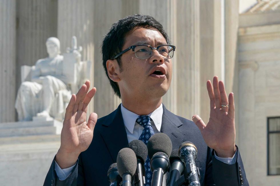 Dale Ho, an attorney for the American Civil Liberties Union, speaks to reporters after he argued before the Supreme Court against the Trump administration