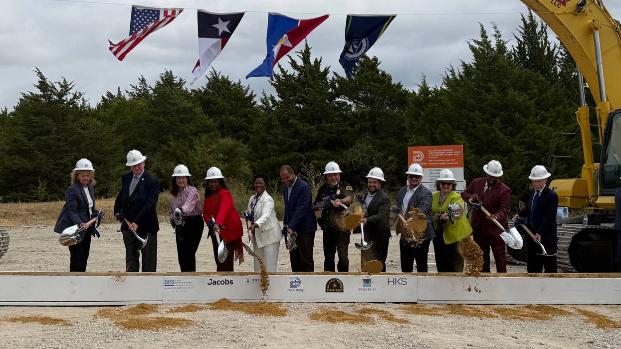 Dallas city officials at groundbreaking, holding shovels, tossing dirt