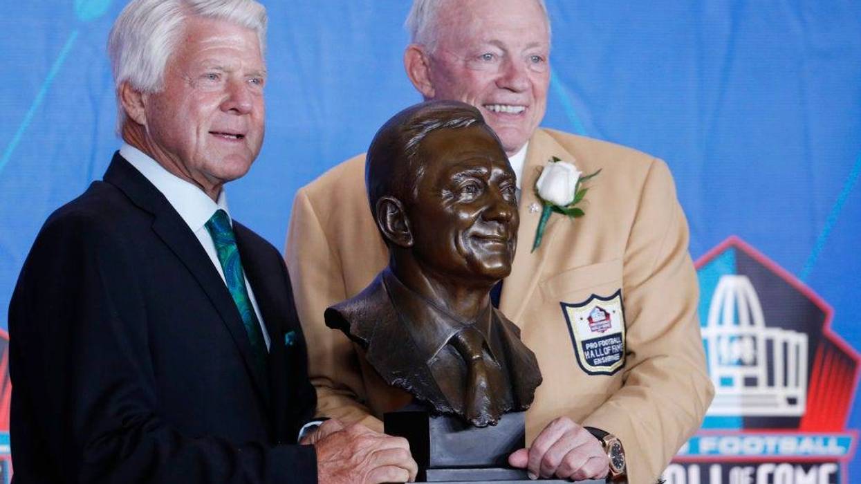 Dallas Cowboys owner Jerry Jones and presenter Jimmie Johnson pose with Jones' bust during the Pro Football Hall of Fame Enshrinement Ceremony at Tom Benson Hall of Fame Stadium on August 5, 2017 in Canton, Ohio.