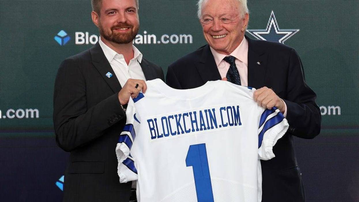 Dallas Cowboys owner Jerry Jones (R) presents Blockchain.com CEO Peter Smith with a jersey after announcing a historic partnership at The Star in Frisco on April 13, 2022 in Frisco, Texas.