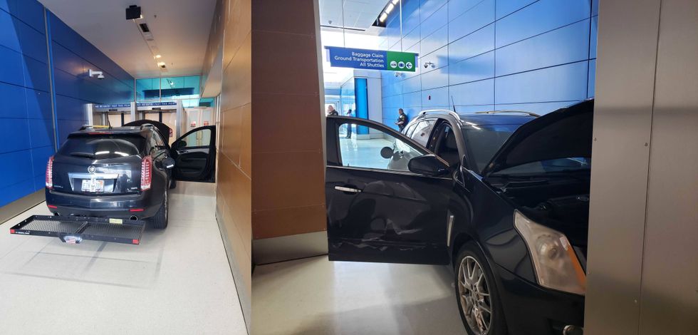 Damaged black SUV with open hood and door inside an airport terminal near "Baggage Claim" sign.