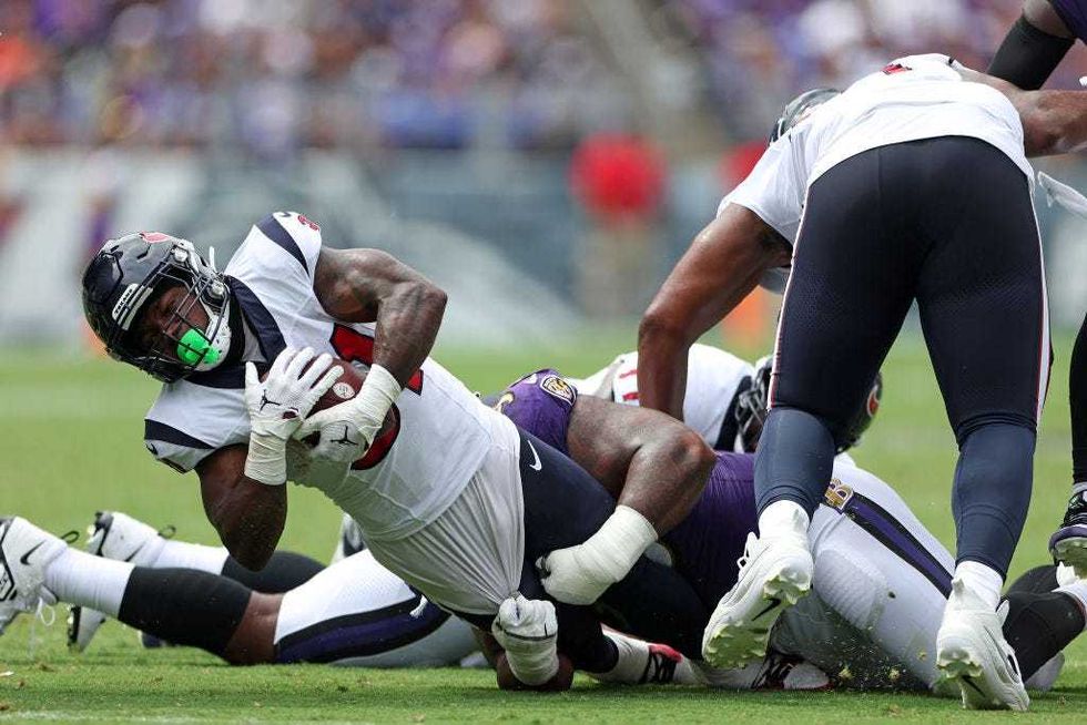 Dameon Pierce is tackled by Travis Jones of the Ravens during the first half at M&T Bank Stadium on Sept. 10, 2023 in Baltimore, Maryland.