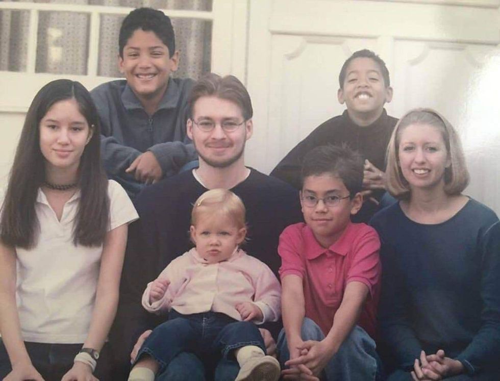 Dan Pearson (center), author of an Inquirer op-ed on transracial adoption, is pictured with his siblings and cousin.