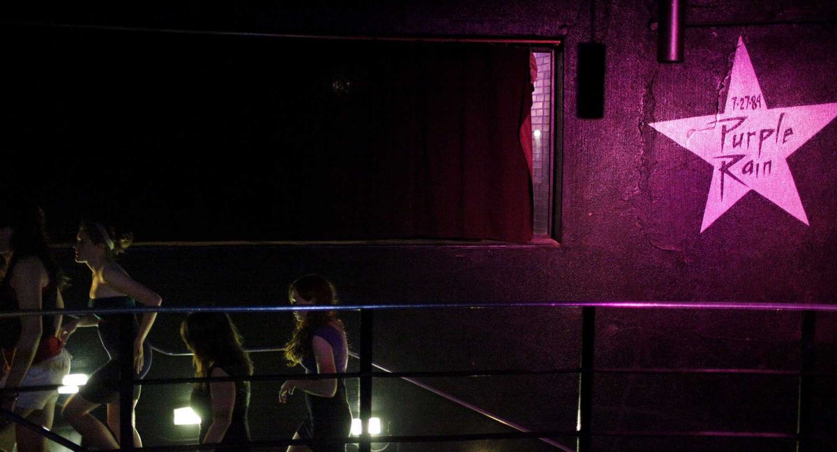 Dancegoers make their way up the stairs under the star of "Purple Rain," July 17, 2009, at First Avenue during the "Let's Go Crazy" dance party to mark the 25th anniversary of "Purple Rain," which was filmed largely at the Minneapolis night club.