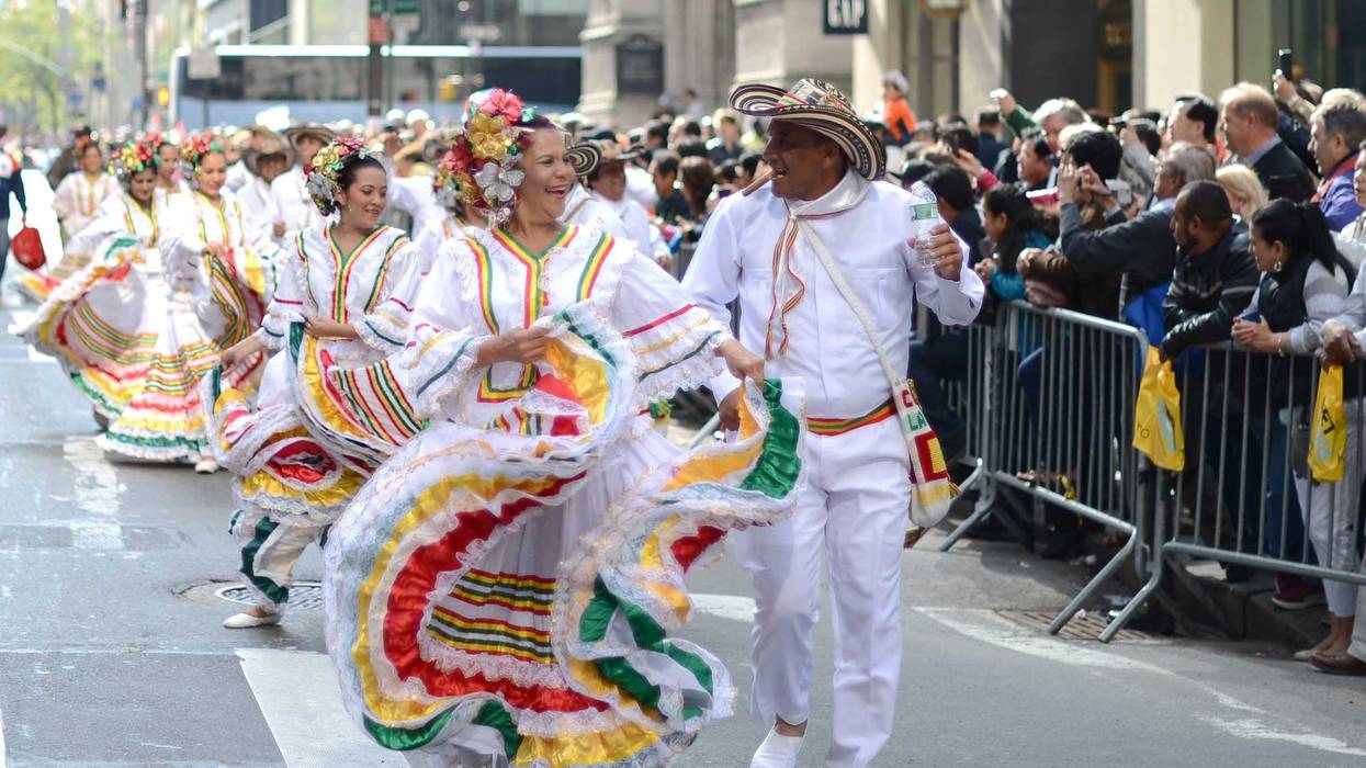 Dancers in colorful costumes pass on the Fifth Avenue in Manhattan, New York City, USA, during the Hispanic Day parade.
