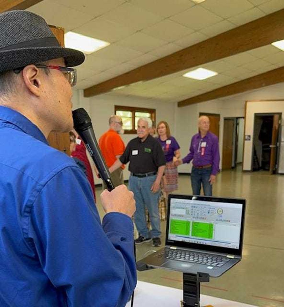 Dancers listen to the call and move around the floor