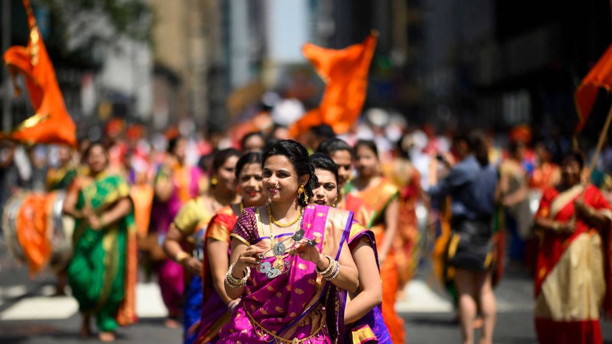 Dancers take part in the Indian Day Parade on Madison Avenue in Manhattan on August 18, 2019
