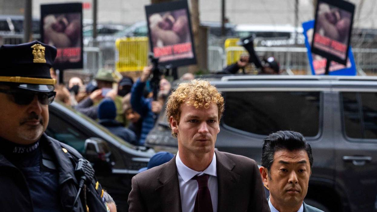 Daniel Penny arrives at the Manhattan Criminal Courthouse on Dec. 9, 2024, as protesters hold up images of him restraining Jordan Neely on a subway train in 2023