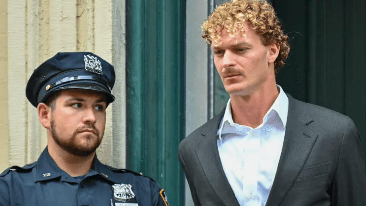 Daniel Penny is escorted in handcuffs by the NYPD after turning himself into the 5th Precinct on May 12, 2023.