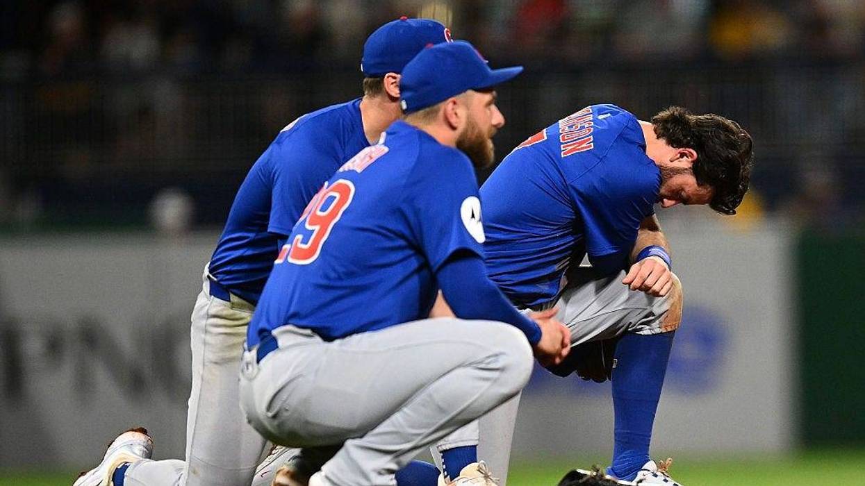 Dansby Swanson #7 and Michael Busch #29 of the Chicago Cubs look on after a fan fell from the stands during the seventh inning against the Pittsburgh Pirates at PNC Park