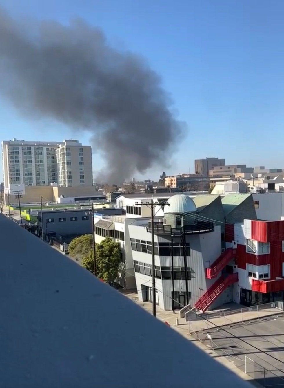 Dark clouds of smoke rose into the Oakland sky Saturday after a boat attached to a parked trailer caught fire.