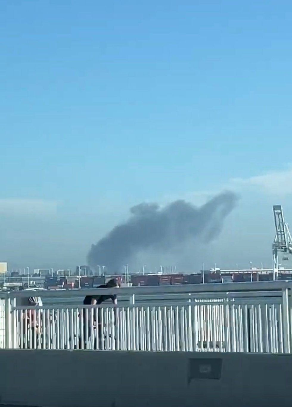 Dark clouds of smoke rose into the Oakland sky Saturday after a boat attached to a parked trailer caught fire.