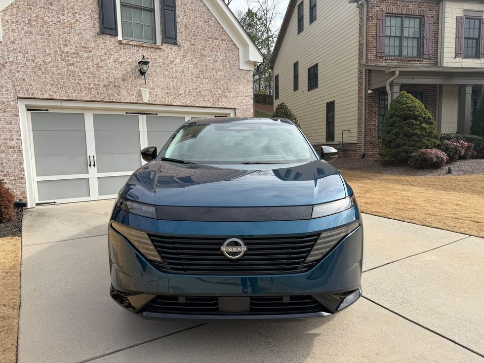 Dark teal Nissan Murano SUV, head-on view, parked in a residential driveway.