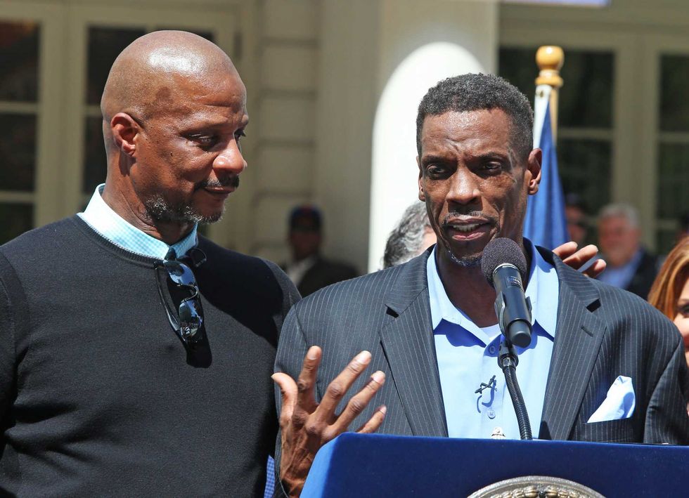 Darryl Strawberry puts a comradely arm around Dwight Gooden while standing on podium on April 28, 2017 in New York City. Gooden, who has long struggled with alcohol & cocaine addiction, had been incapacitated & unable to participate in the team