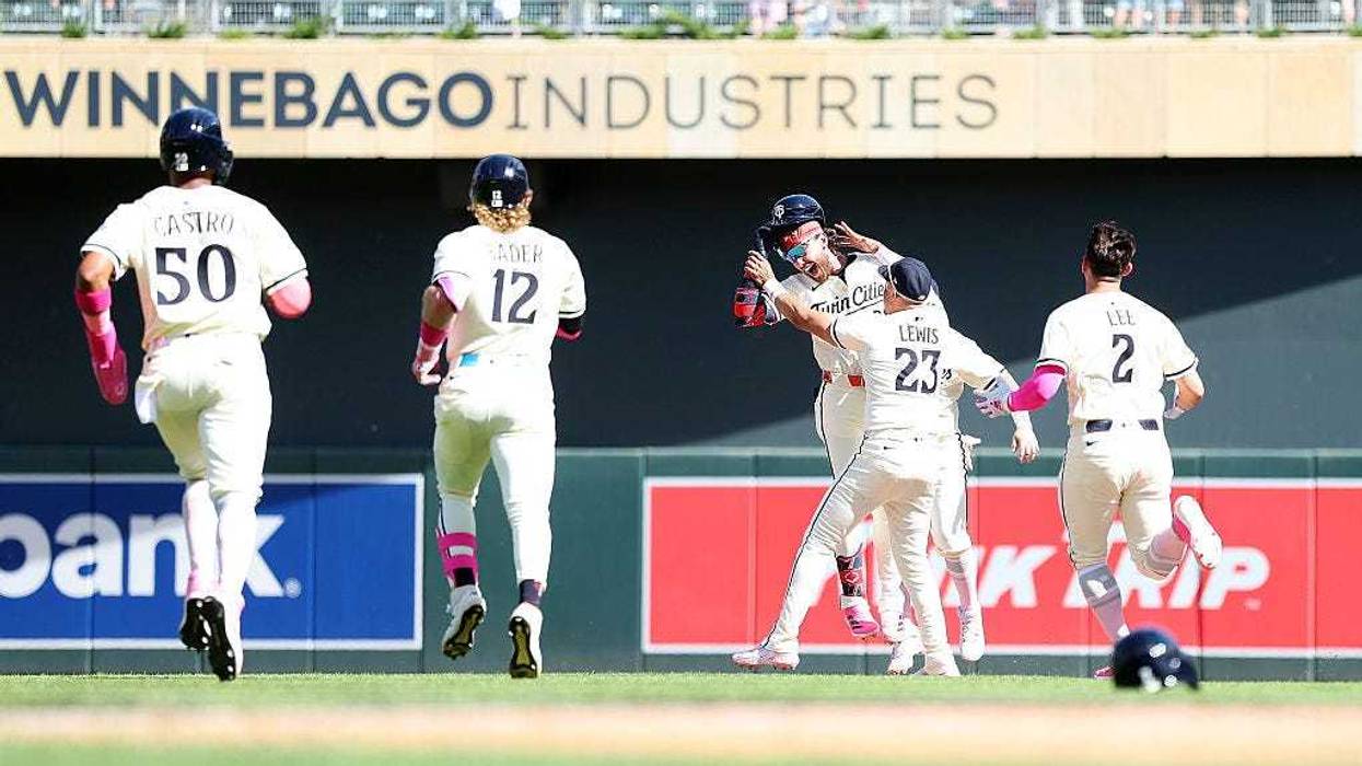 DaShawn Keirsey Jr. #21 of the Minnesota Twins celebrates his walk-off single against the San Francisco Giants with teammates in the tenth inning at Target Field on May 11, 2025 in Minneapolis, Minnesota. The Twins defeated the Giants 7-6 in ten innings.