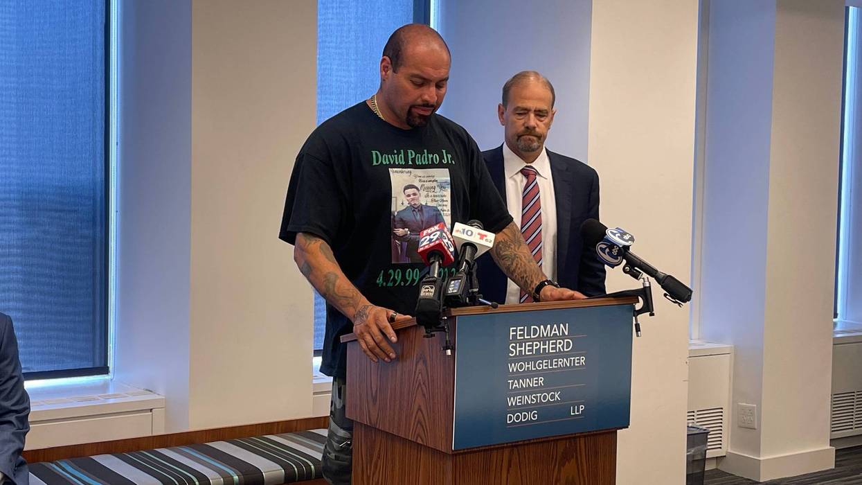 David Padro Gonzalez, father of David Padro Jr., holds back tears as he speaks at a podium next to his attorney, July 27, 2023.