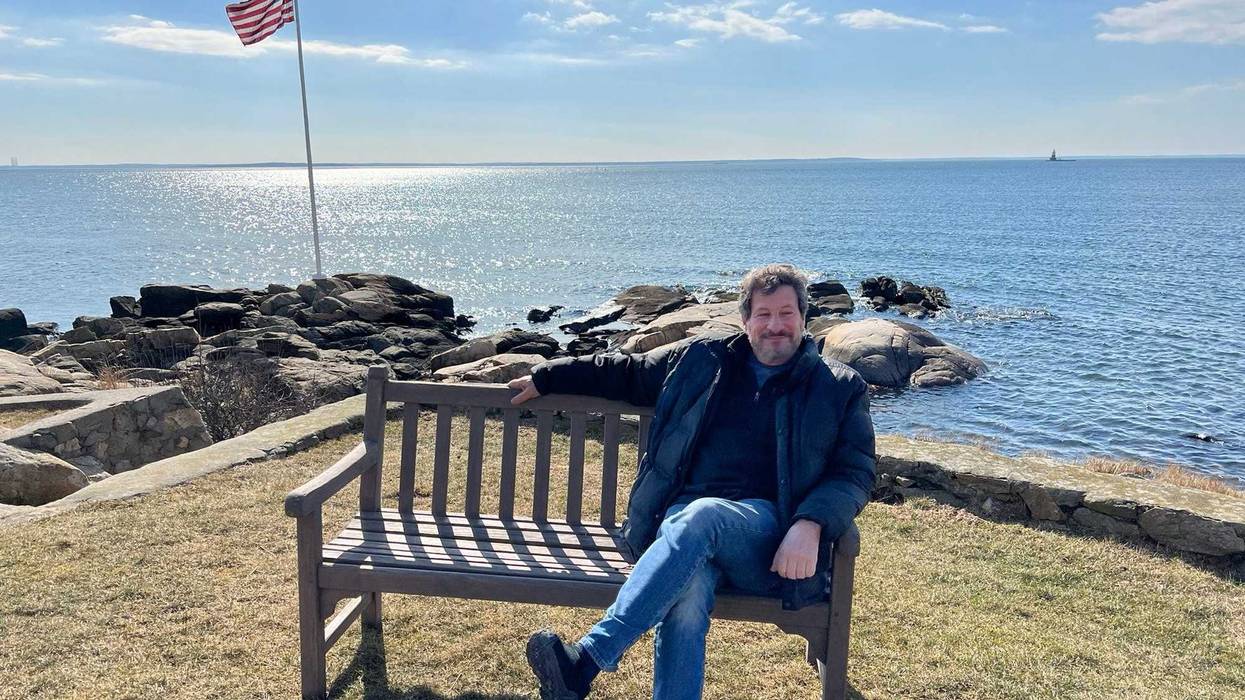 Dean Hacohen sits at the memorial bench on Rocky Point in Norwalk