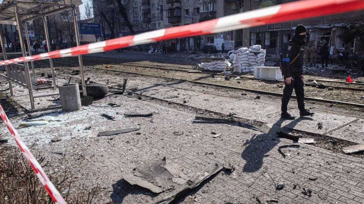 Debris from a damaged residential apartment block caused after a Russian rocket was shot down