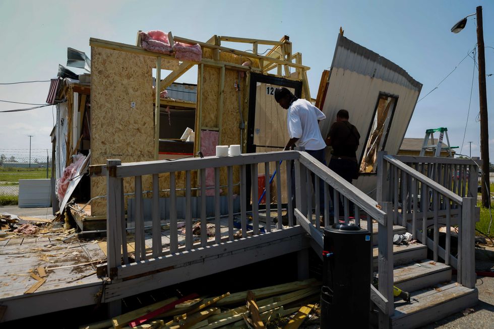 Debris is cleared at a collapsed car rental office after Hurricane Ida in Laplace, Louisiana, U.S., on Thursday, Sept. 2, 2021. The electric utility that serves New Orleans has restored power to a small section of the city after Hurricane Ida devastated the region