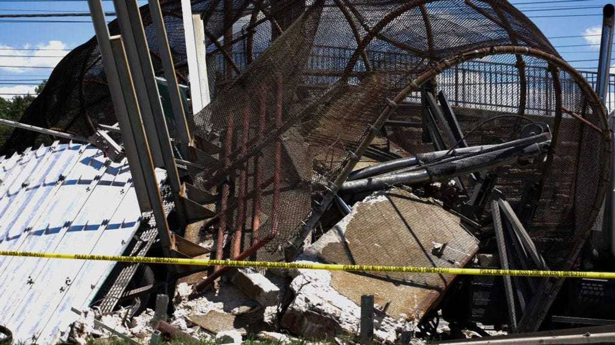 Debris is seen after a pedestrian bridge collapsed on June 23, 2021 in Washington, DC. At least six people were reportedly injured on Wednesday when a pedestrian bridge collapsed onto DC-295 and trapped a truck containing 500 pounds of diesel fuel. (Photo by Anna Moneymaker/Getty Images)